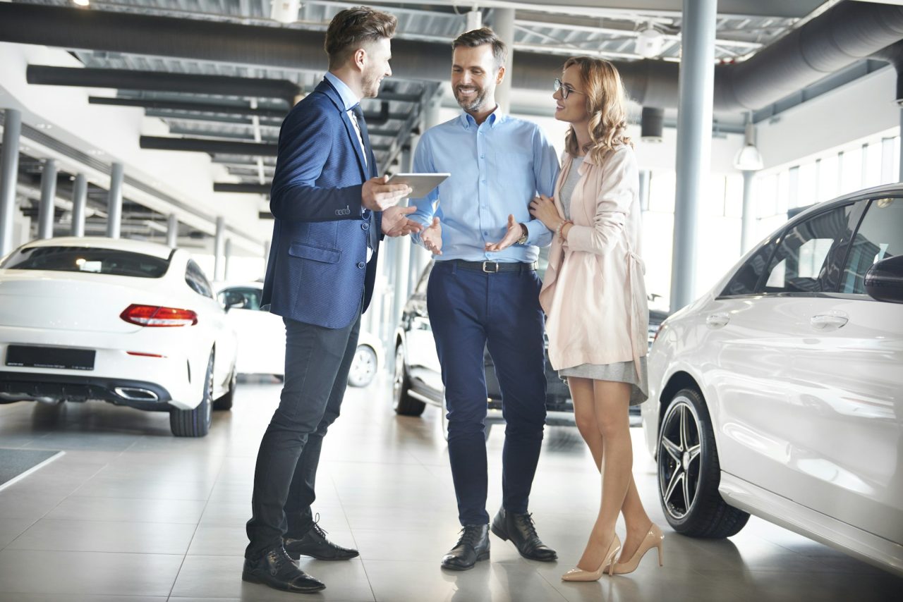 couple-purchasing-brand-new-car